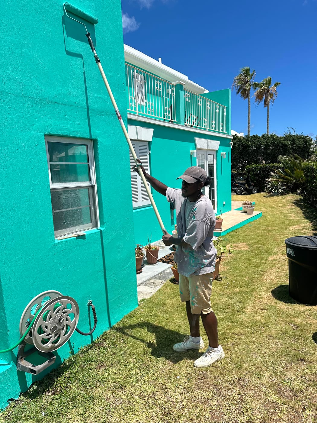 T&H Painting crew painting a Bermuda home exterior