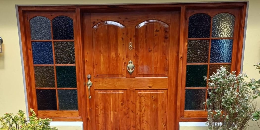 Bermuda cedar front door restained by T&H Painting